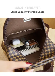 Detail view of large capacity multi-compartment interior for brown printed leather bag