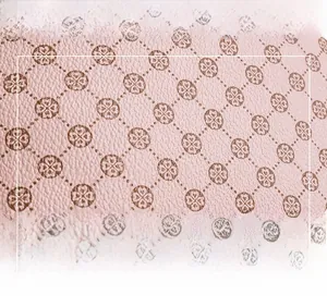 Close-up of pink synthetic leather material featuring a vintage brown clover pattern