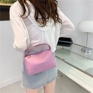 Lavender lychee pattern women pillow handbag with gold chain strap shown from back angle