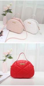 Close-up of quilted shell handbags in pink, white, and red with metallic hardware