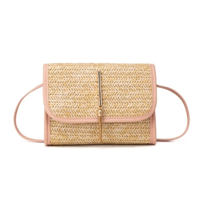Straw woven crossbody bag with pink leather trim and golden tassel detail for women