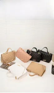 Group of chain bags in beige, pink, black and white with quilted and V-stitch patterns