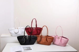 Détail de sacs cabas en daim en cinq couleurs avec porte-monnaie et breloques flamants