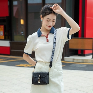Mini black crocodile pattern square bag with pearl tassel and wide strap on female model