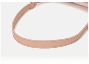 Detail of pink faux leather strap with fine stitching on a vintage baguette bag