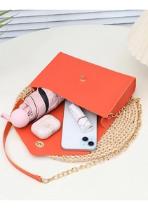 Detailed top view of orange PU leather crossbody bag showing spacious interior with golden clasp
