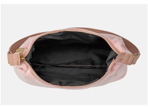 Overhead view of pink suede hobo bag interior with black lining and golden zipper detail
