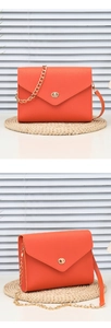 Detailed views of bright orange pebbled leather envelope bag with gold twist lock