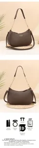 Detailed view of the brown crescent bag interior capacity for cosmetics and tech accessories