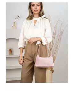 Detail of pink faux fur baguette bag showing soft plush texture and minimalist shape
