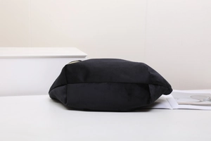 Détail de la trousse à maquillage en velours noir avec fermeture dorée et fond large plat