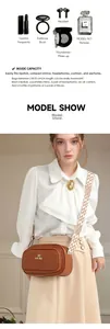 Brown crossbody camera bag interior showing space for lipstick and earphones