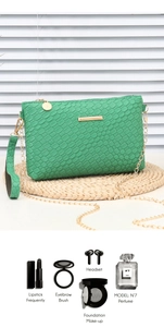Detail view of green woven mini bag capacity with gold chain strap and accessories