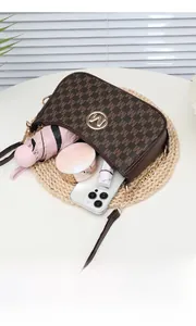 Detail showing internal capacity of brown monogram crossbody bag with daily essentials