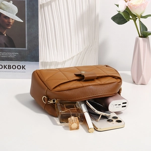 Brown quilted PU leather handbag with gold hardware showing its spacious interior capacity