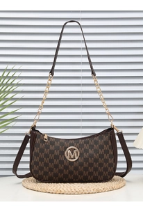Detail of crescent bag featuring vintage letter print and decorative gold chain