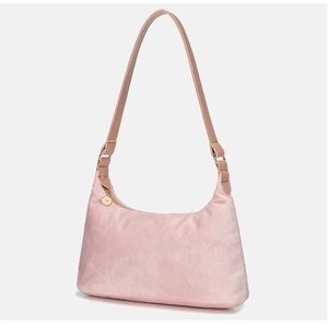 Detail of plush faux fur shoulder bag in soft pink with golden circular zipper charm