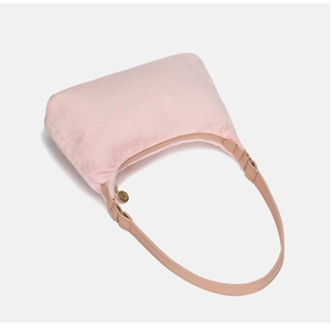 Close-up of pink fuzzy hobo bag with gold zipper and faux leather shoulder strap