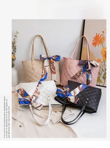Close-up of quilted tote bags in various colors featuring silk scarf handle decor