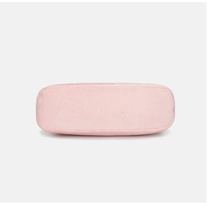Flat base detail of a soft pink fuzzy underarm bag showing plush velvet texture
