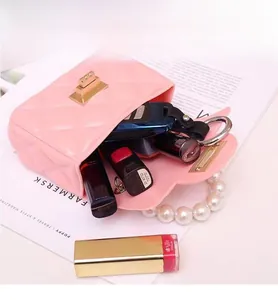 Pink quilted crossbody bag interior capacity with pearls handle and luxury gold lock