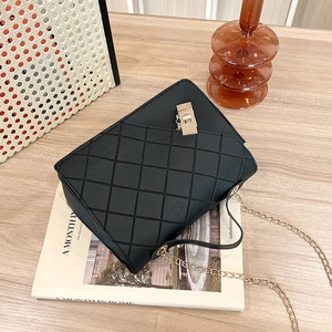 Classic black quilted crossbody bag with golden chain strap and elegant square lock buckle