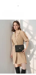 Detail view of black lychee grain leather crossbody bag with golden metal twist lock
