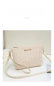 Detail of beige woven straw shoulder bag with herringbone texture and gold logo