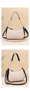 Detailed view of pink lychee leather underarm bag with gold chain and black strap