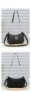 Detail of crescent shoulder bag featuring gold M logo and chain strap on woven mat