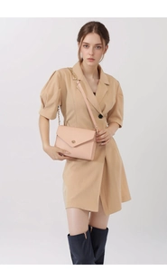 Pink pebbled leather envelope bag with gold twist lock styled with a blazer dress