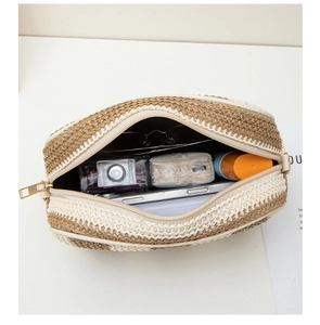 Top view of striped straw camera bag showing interior capacity for essentials