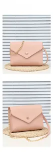 Detailed view of pink textured leather shoulder bag with golden clasp and chain strap