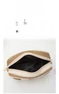Detail view of woven straw makeup bag with stripe pattern and spacious interior for cosmetics