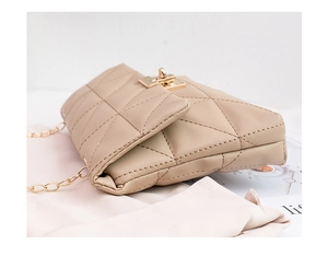 Close-up of beige quilted cloud bag showing gold swivel lock and chain strap details