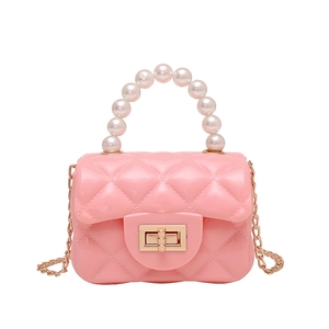Pink jelly handbag with classic diamond quilting, pearl handle and gold chain strap