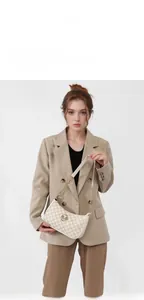 Detail of off-white crescent bag with letter print, gold chain, and logo on khaki suit