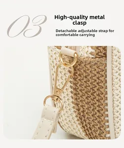 Detail of golden D-ring hardware and detachable strap on woven crossbody camera bag