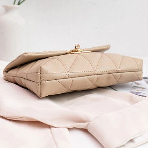 Quilted beige leather handbag with gold twist lock and elegant crossbody chain strap