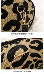 Detail of leopard print fabric with golden hardware and brand logo on cylinder bag