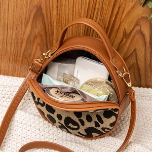 Retro round crossbody bag with leopard print accent and caramel leather finish