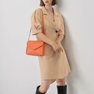Bright orange pebble leather envelope crossbody bag with gold chain and metal lock