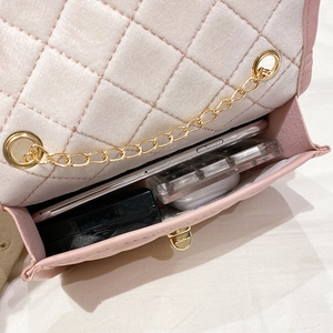 Vue interne du sac à chaîne matelassé rose montrant l'espace pour téléphone et maquillage
