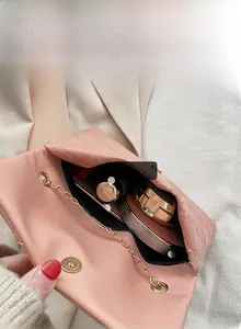 Pink quilted crossbody bag interior showing storage for phone, power bank and cosmetics
