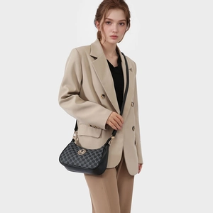 Retro monogram hobo bag in black leather with gold M logo and slim shoulder strap
