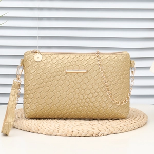 Champagne gold woven crossbody bag with metallic chain strap and top zipper closure