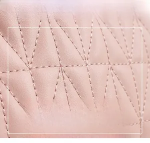 Close-up of pink quilted faux leather with detailed rhombic stitching and texture