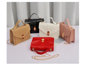 Close-up of crocodile pattern leather mini bags with gold chain and floral pearl buckle