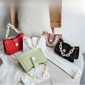 Detailed view of crocodile pattern crossbody bags in five colors with chain straps