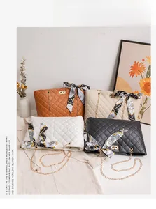 Close-up of quilted leather handbags featuring gold chain straps and decorative silk scarves